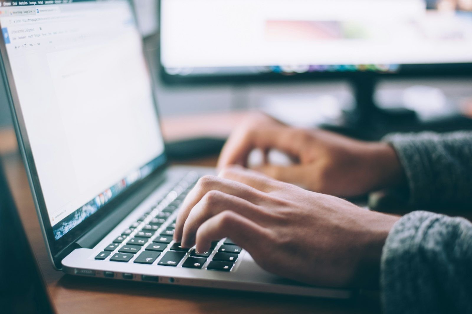 Writer working on a content calendar at a desk with a laptop and notebook