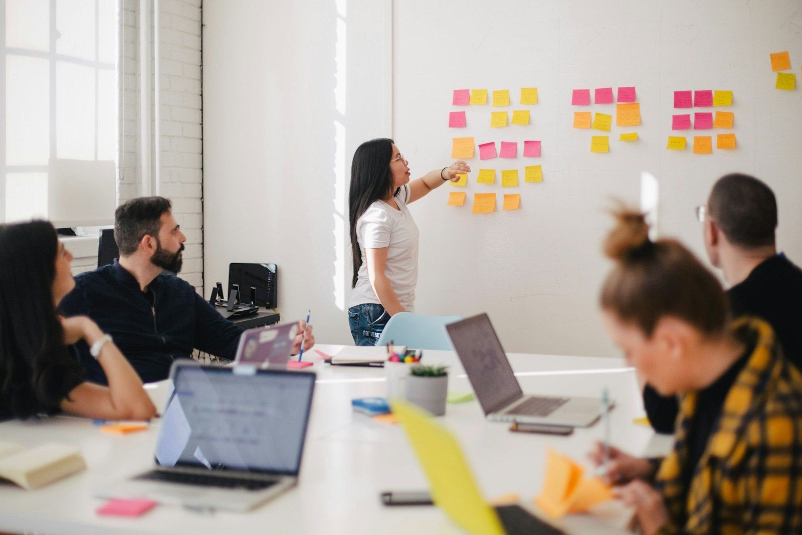 Marketing team collaborating around a whiteboard planning brand messaging